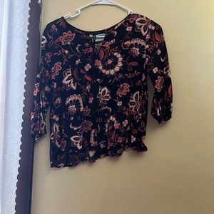 This is a black floral blouse.